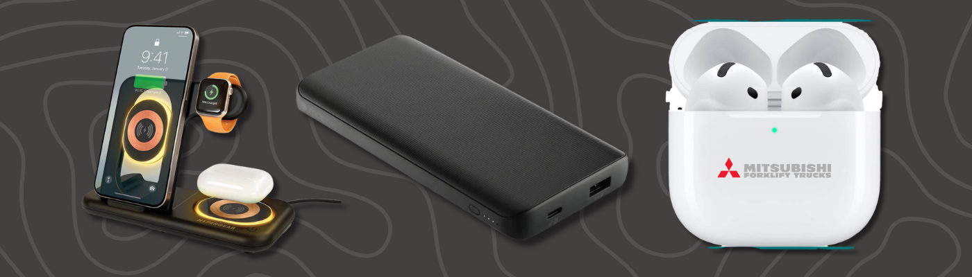 Smartphone charging dock with a smartwatch and earbuds, a black power bank, and a Mitsubishi-branded wireless earbuds case on a dark background.
