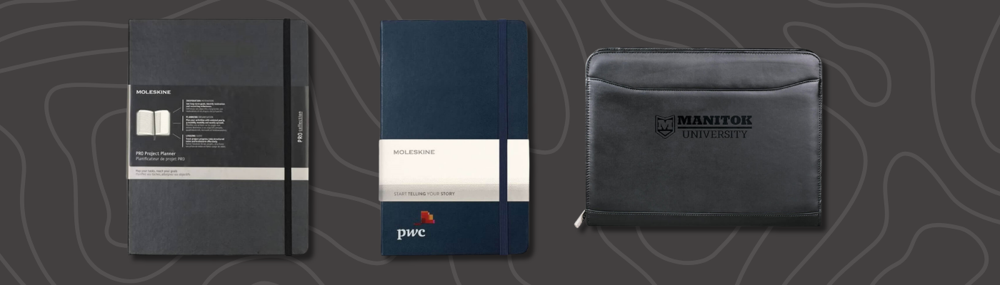 Best Corporate Branded Gifts, including Moleskine notebooks and Manitou University leather portfolio on a dark patterned background.