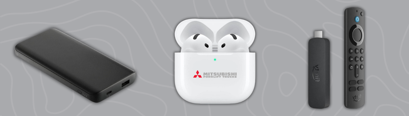 Black power bank, Apple AirPods with Mitsubishi branding, and Fire TV Stick remote on gray background