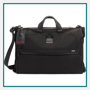 Black TUMI duffel bag with dual carry handles, detachable shoulder strap, front zipper pockets, and luggage tag, featured as one of the best luxury corporate gifts for executives.