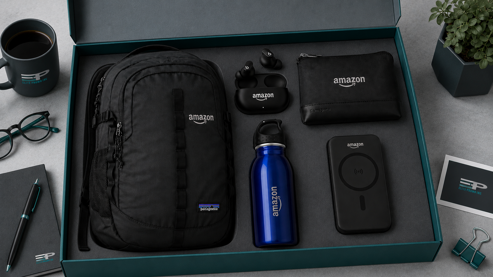 Best employee welcome kits image featuring an Amazon branded operations team kit with backpack, wireless earbuds, travel pouch, blue water bottle, and wireless charger arranged in a beige gift box.