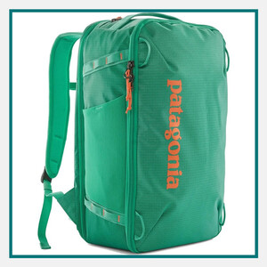 Patagonia 30L Black Hole Mini MLC in green with orange Patagonia branding, padded backpack straps, zippered compartments, and travel-ready carry design.