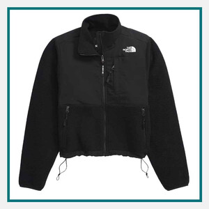 The North Face Ladies' Retro Denali Jacket in black with a full-zip front, stand collar, zippered chest and side pockets, and adjustable hem cords.
