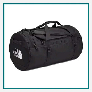 The North Face Large Base Camp Duffel in black with carry handles, multiple straps, zippered compartments, and The North Face logo on the end panel.