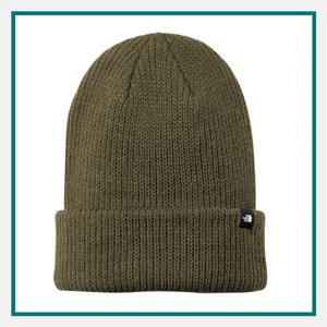 The North Face Truckstop Beanie in olive green with a ribbed knit texture, folded cuff, and small The North Face logo tag on the front.