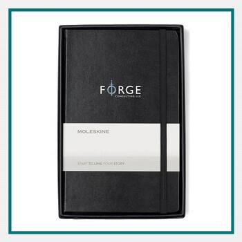 Black hardbound Moleskine® Large Notebook Gift Set featuring a notebook and pen, displayed as premium conference swag on a white background.