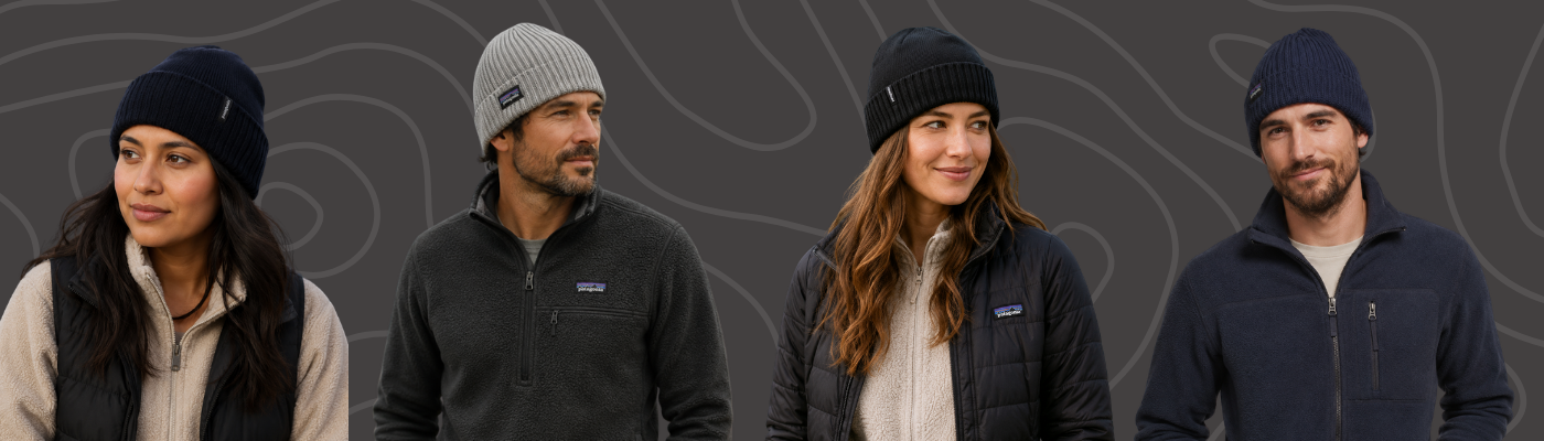 Four models wearing Patagonia beanies with fleece jackets and insulated outerwear, set against a dark grey patterned background.