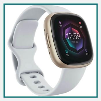 Gold‑tone Fitbit Sense 2 smartwatch with white silicone band displaying health metrics on screen– corporate gifts for clients.