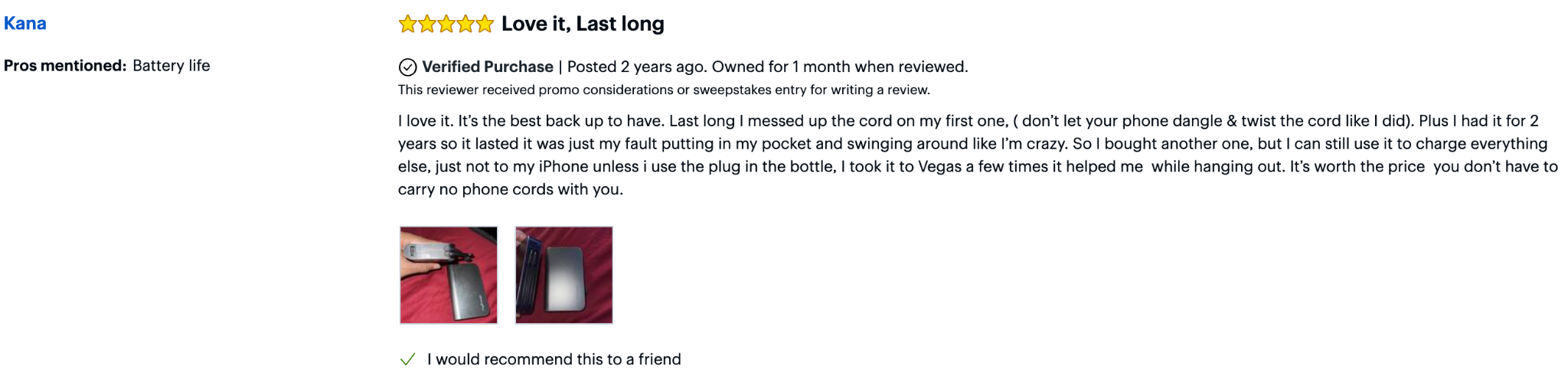 User’s worn myCharge HUB Turbo 10,050 mAh charger lying on a red surface with its built-in plug extended, showing signs of heavy use mentioned in the review.