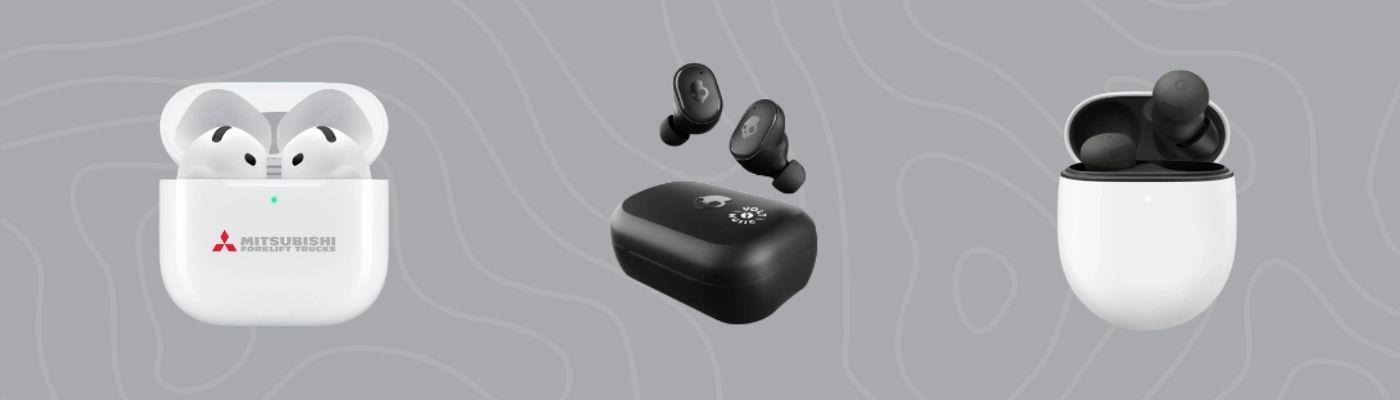 Wireless tech gifts, including branded white earbuds, black Skullcandy earbuds, and sleek white earbuds with silicone tips arranged on a dark, patterned background.